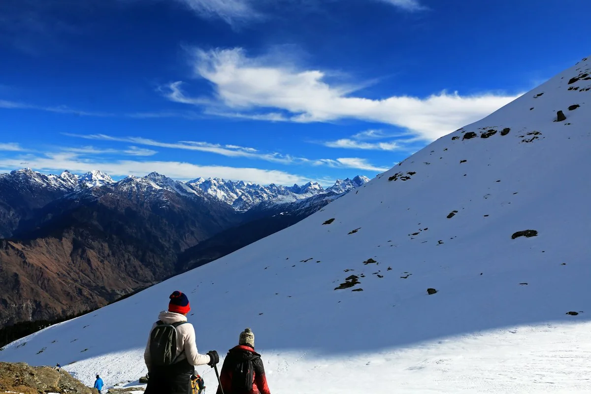 Travellers looking out over a Himalayan valley at sunrise